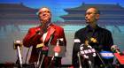 Thumbnail of Louis (Ying Da) and YoYo (Ge You) auctioning product placements in Big Shot's Funeral